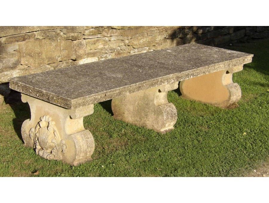 A vintage composition stone bench