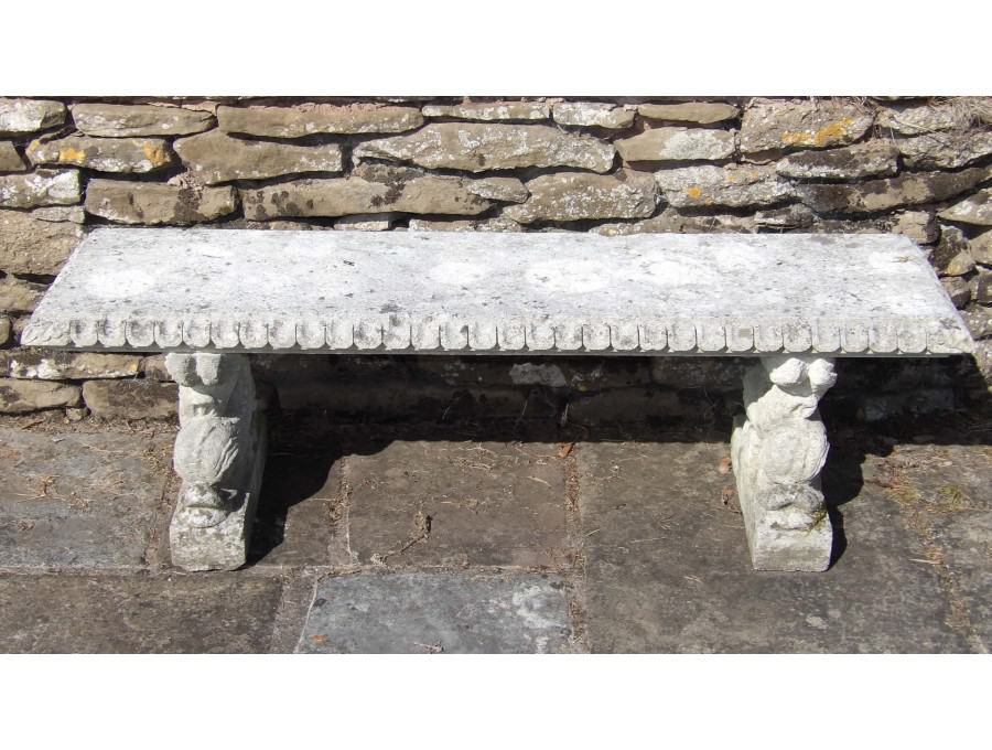 Face on view of stone garden bench 