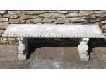 Face on view of stone garden bench 