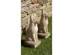 A pair of weathered stone foxes