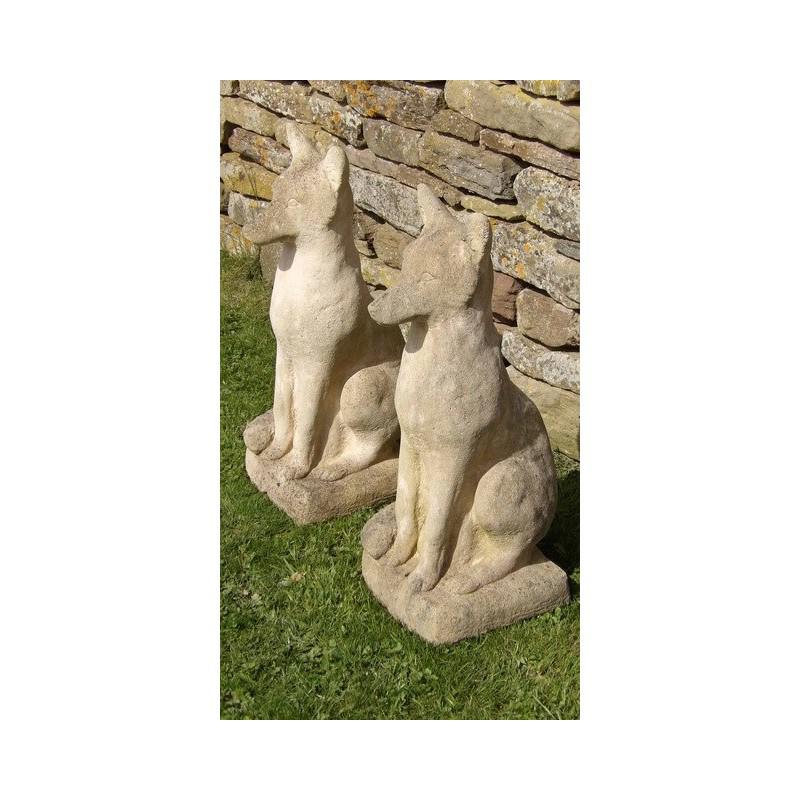 A pair of weathered stone foxes