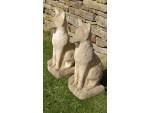 A pair of weathered stone foxes