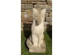 A pair of weathered stone foxes