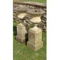 A pair of weathered garden urns