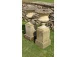 A pair of weathered garden urns