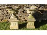 A pair of weathered Haddonstone urns