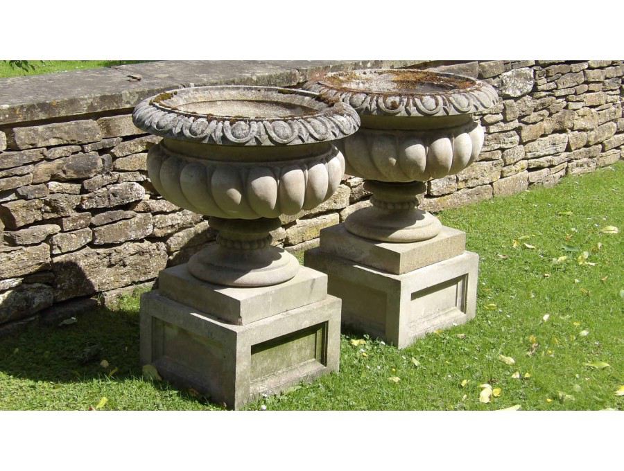 A Pair of Weathered Haddonstone Urns