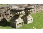 A Pair of Weathered Haddonstone Urns