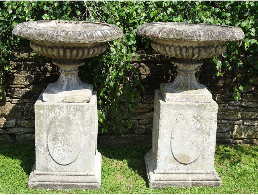 Weathered Urns on Plinths (Pair)